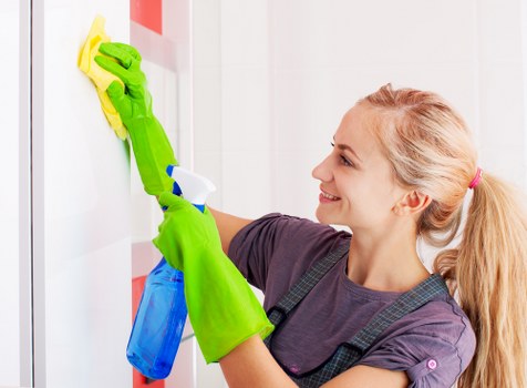 Domestic cleaner working in a tidy Deepcleaning living room